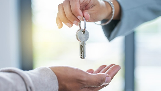 Person handing another person keys